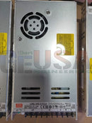 Silver metal power supply unit with black circular vent and yellow warning labels on gilbert engineering usa commercial grade cabinet