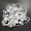 A tangled string of clear faceted led pixabulb strings with white plastic bases by gilbert engineering usa dc12v green black white