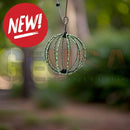 Green wireframe spherical bird feeder with black accents and hanging loop perfect for holiday decor lighting