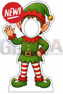 Green and red elf cutout photo op prop with striped leggings gold buttons and a bell topped hat for interactive photo fun