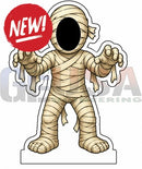 A beige mummy figurine wrapped in bandages with a black face hole and outstretched arms for interactive photo op props