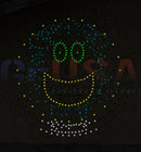 A hattitude quartet spinner singing face made of green and yellow led lights with white dots by gilbert engineering usa