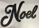 Black noel wall decor in cursive font with dotted perforations laser cut by gilbert engineering usa for mini lights