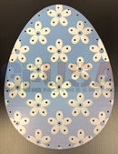 Light blue impression easter eggs decorative panel with cream flowers dark centers and subtle black dots pattern