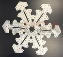 White snowflake-shaped laser cut pegboard with perforated holes and star cutout by gilbert engineering usa