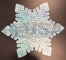 A light blue and white laser cut impression flake decorative mat by gilbert engineering usa with perforated textured surface