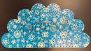 Blue snowflake patterned decorative mat with cream snowflakes and black perforations from impression peacock arch by gilbert engineering usa