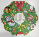 A festive green christmas wreath mirror with laser cut santa claus and holiday prints by gilbert engineering usa