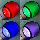 A circular cylindrical rgb landscape light with a sleek metallic finish and vibrant red green blue or purple lens by gilbert engineering usa