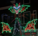 A glowing rgb pixel impression pyrothor wings display featuring a green and red pyrothor head above a christmas tree