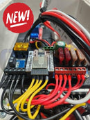 A compact black quin-led-dig-quad 12v or 24v controller circuit board with microcontroller and connection ports
