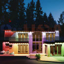 A modern two-story house made of colorful shipping containers with red green purple and yellow illuminated panels using permanent holiday lighting by gilbert engineering usa