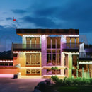 Modern multi-story building with colorful illuminated facades using permanent holiday lighting by gilbert engineering usa laser cut design