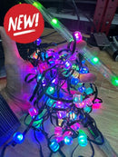 A bundle of colorful evo 12mm pixels led string lights with glowing purple blue green and pink bulbs on black wires