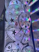 Shiny metallic steel tree toppers with voodoo blue and emerald green star and number cutouts in overlapping layers