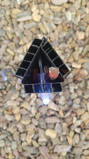Black triangular led light fixture with blue glowing bulb and laser cut wiring from gilbert engineering usa peace family stakes